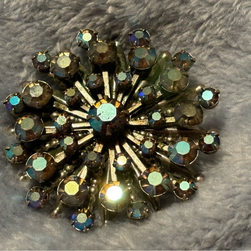 Vintage silver toned Starburst flower with Blue AB stones.